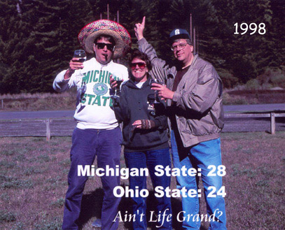 Photograph of artist Barbara Bromley, her husband (right) and brother (left) celebrating the Spartan victory over OSU in 1998 collegiate football